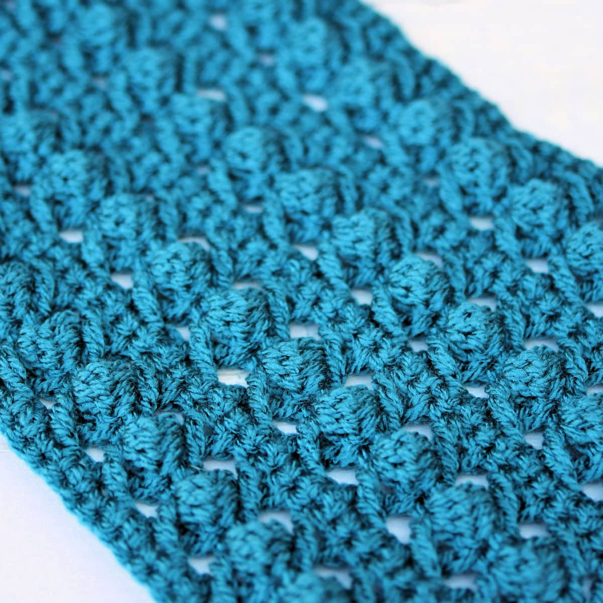 extreme closeup of lacy crossed trebles scarf