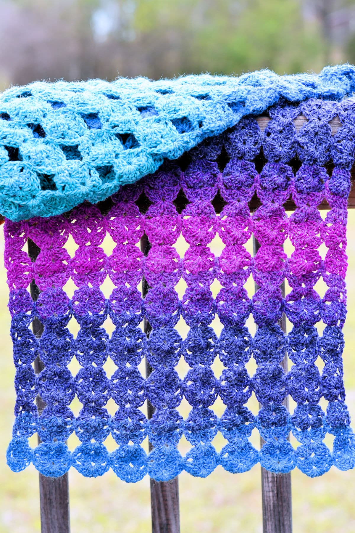 Rectangular Crochet Shawl displayed over a wooden railing