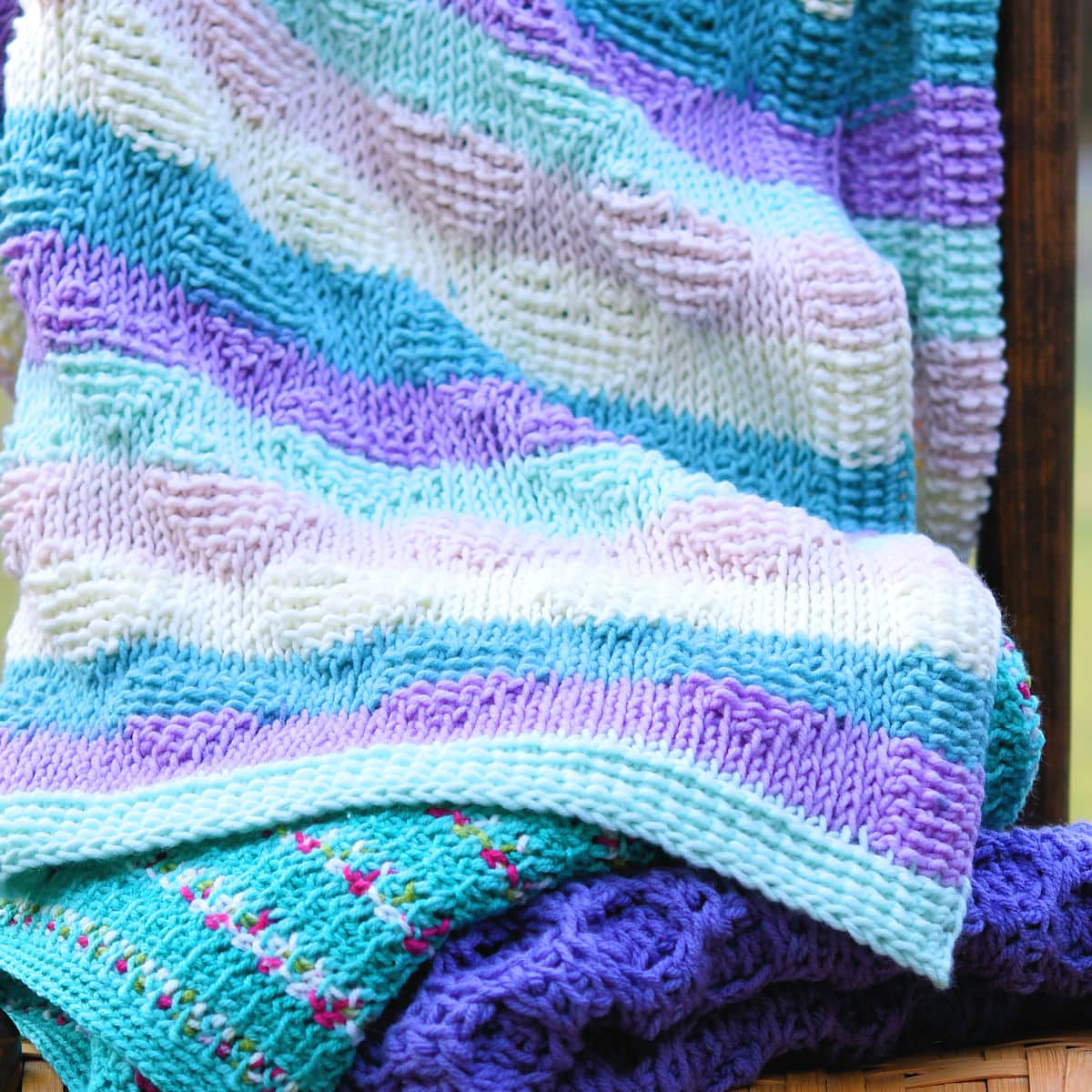 stack of tunisian crochet baby blankets