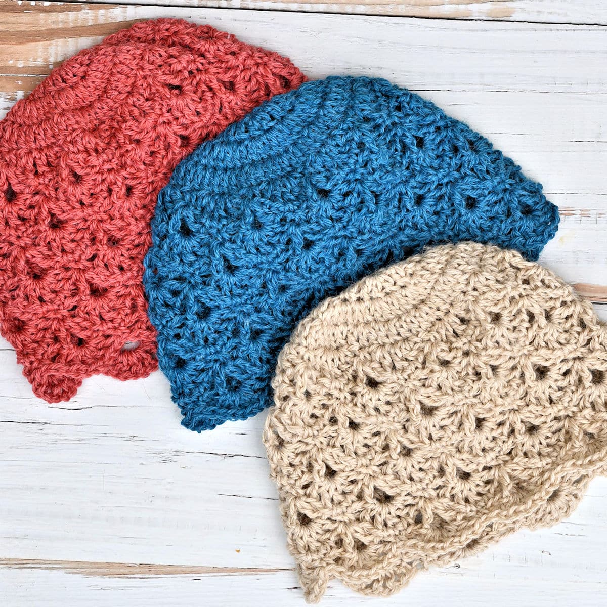 three colors of cranberry lace hat on flat background