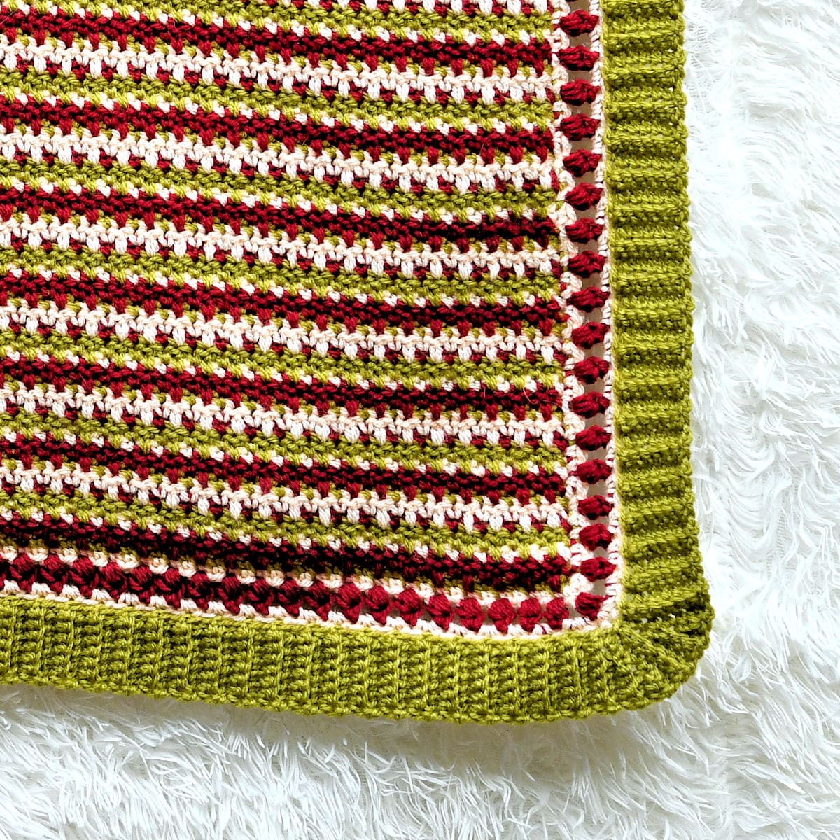 Faux Fair Isle Christmas Afghan from MakeItCrochet showing a closer view of the After Thought Ribbing