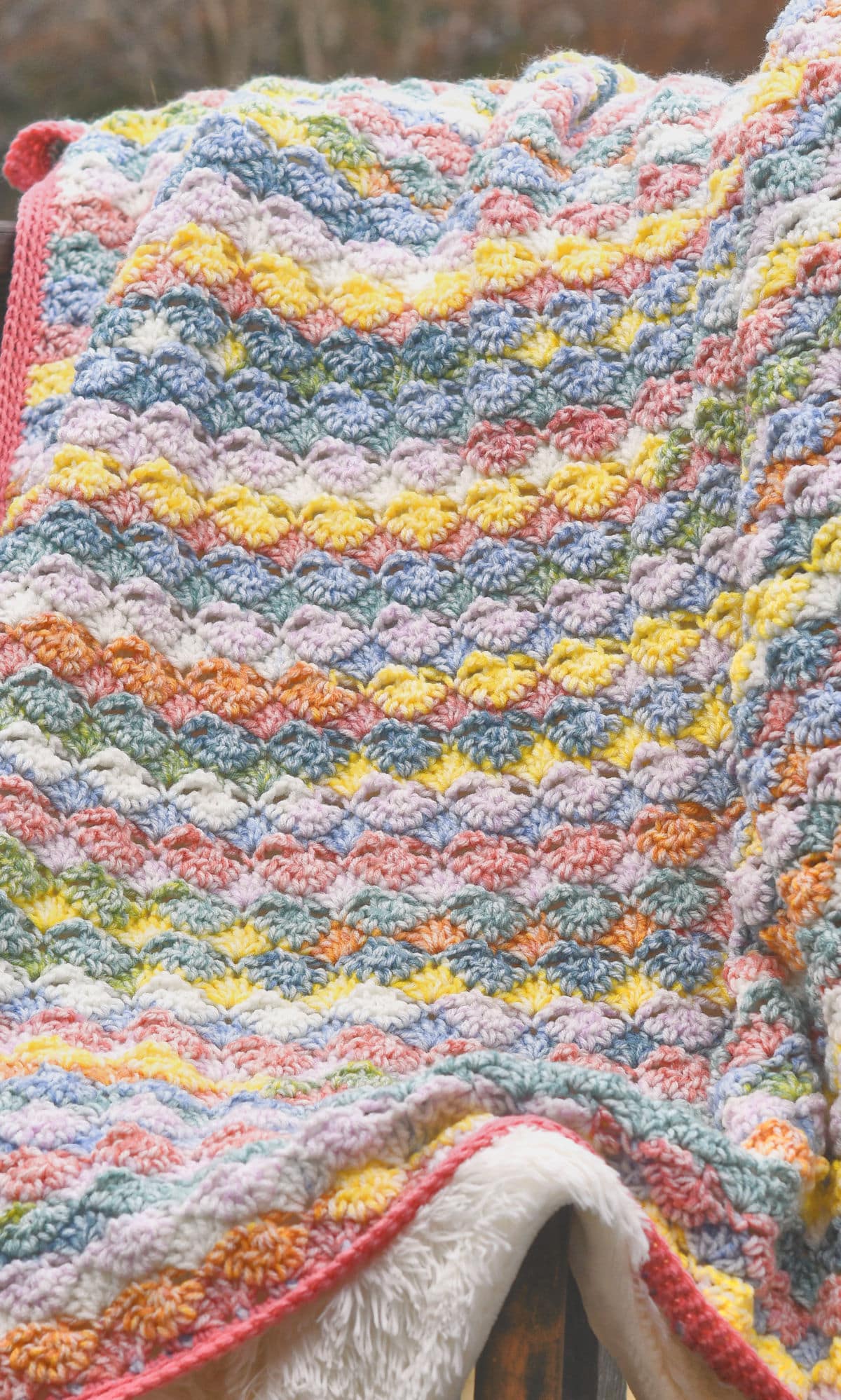 Watercolor Shells Afghan draped on a wooden chair