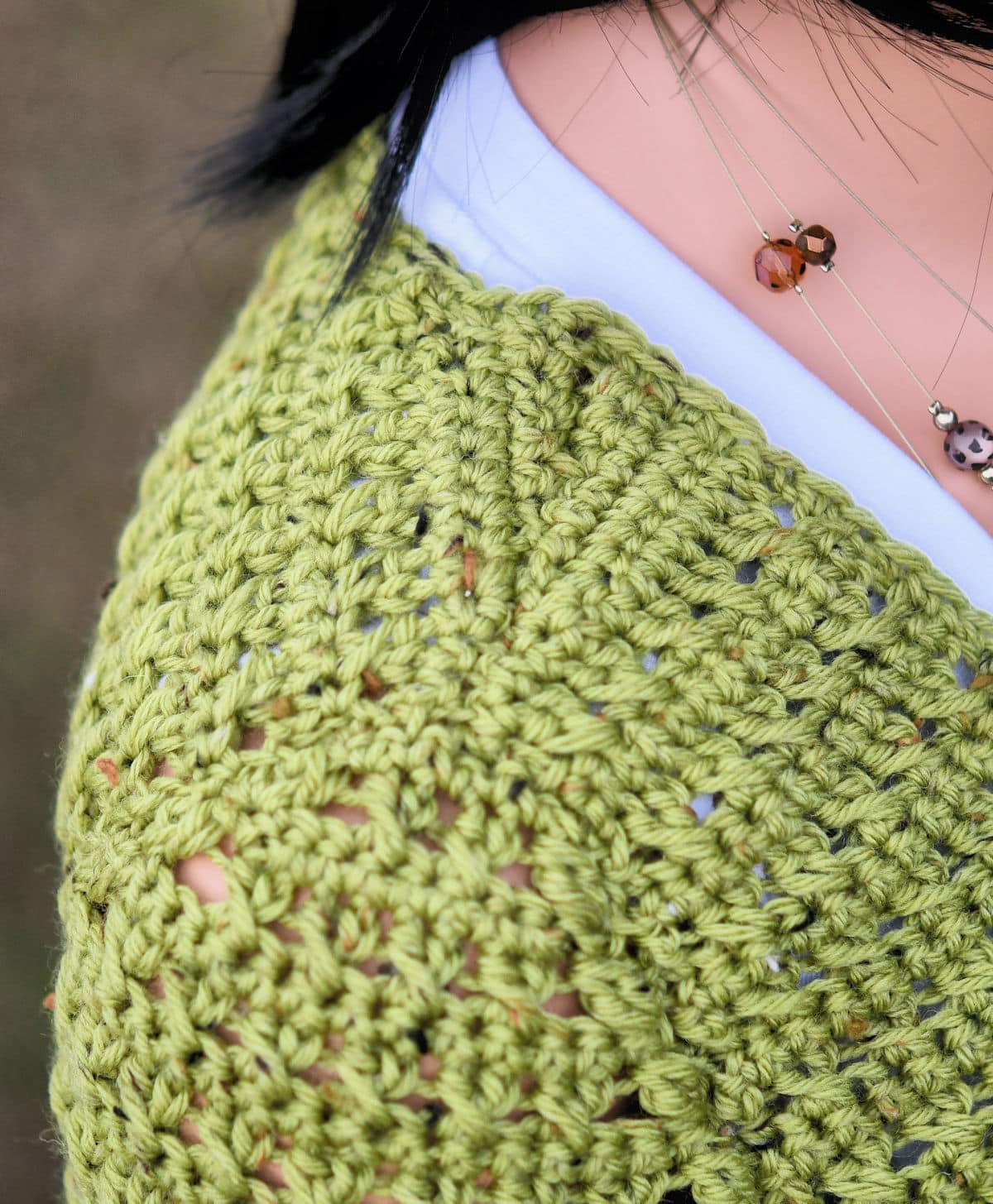 closeup of sloped shoulder construction of crochet cardigan