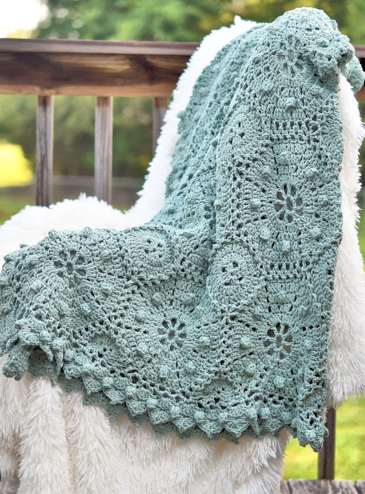 romantic crochet lace throw displayed on a white faux fur background