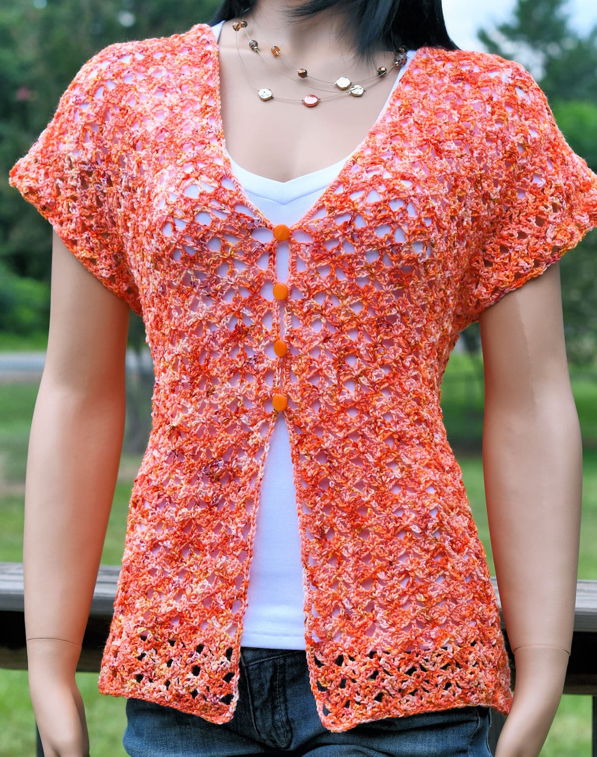 Woman wearing an easy lacy crochet top made with sock yarn.