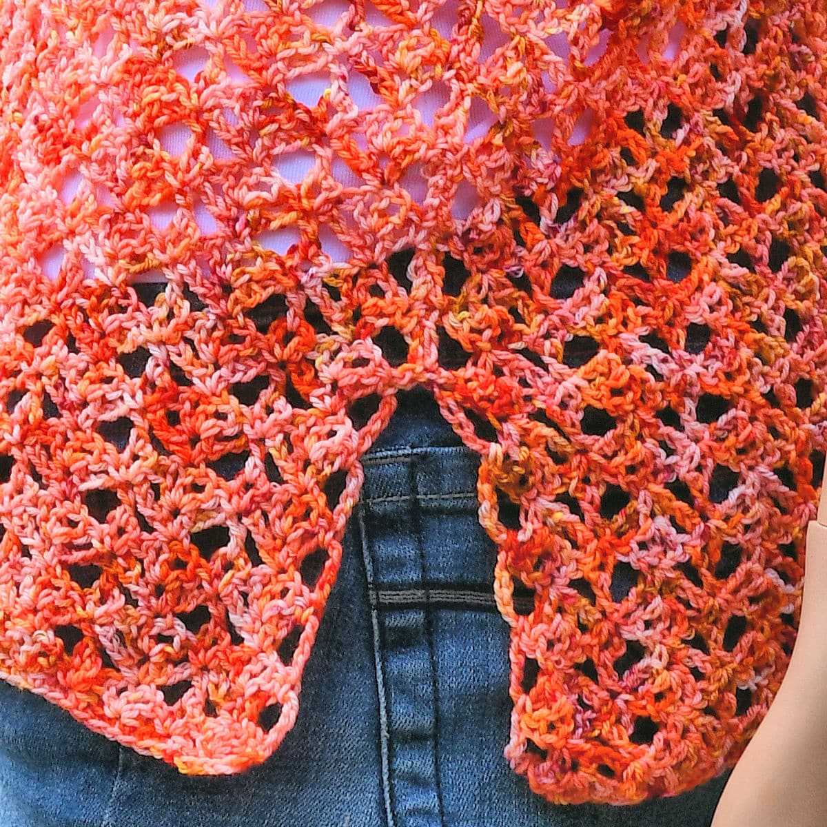 Closeup of womens sock yarn crochet lace top showing the side vents at the waist.